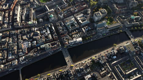 dublin top down aerial view, ireland, downtown, river liffey, traffic on grattan bridge and buildings, high angle birdseye drone shot