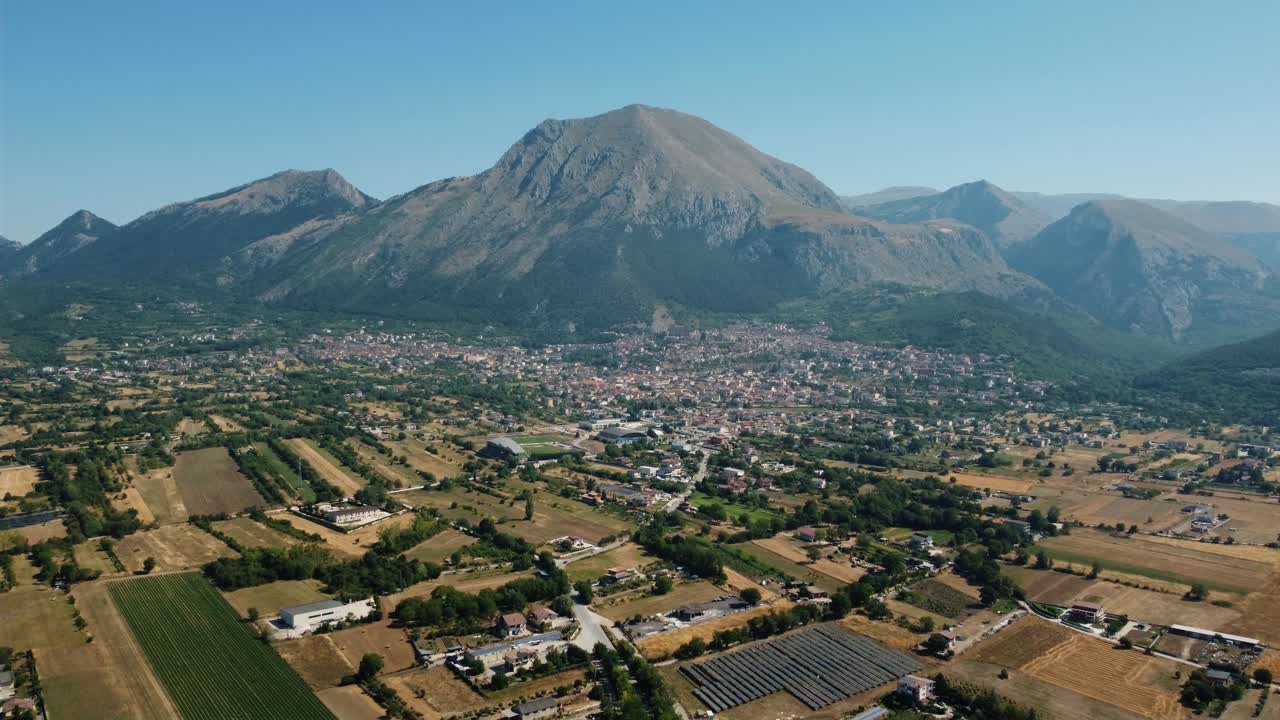 Aerial view of a town in a valley with mountains