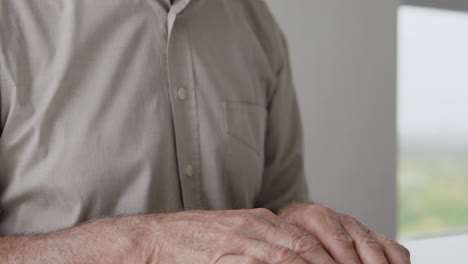 old man folding hands and raising eyes, praying god, asking for health and peace