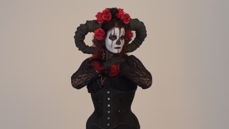 catrina cosplay girl caressing sensually with a light background, medium shot