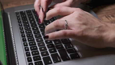 woman hands typing on keyboard laptop