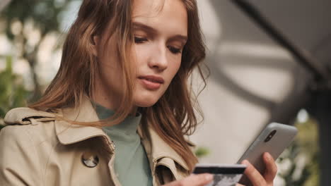 caucasian female student online shopping on smartphone outdoors.