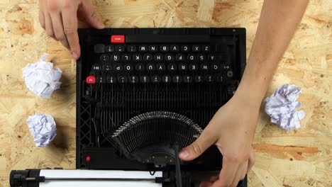 hands repairing a vintage typewriter