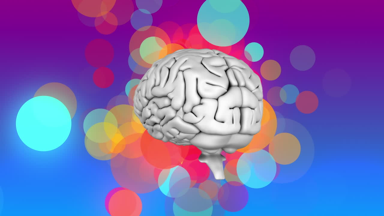 el cerebro humano girando y manchas coloridas de luz flotando contra el fondo de gradiente