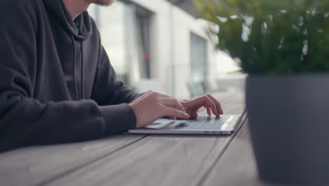 Man-working-outside-withe-the-laptop