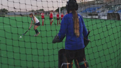 female hockey players playing on the field