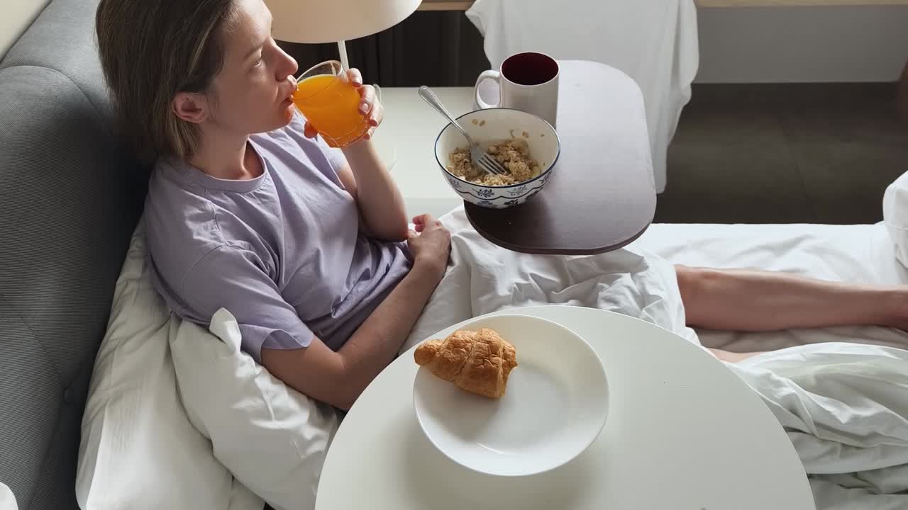 침대에서 아침을 먹는 여자