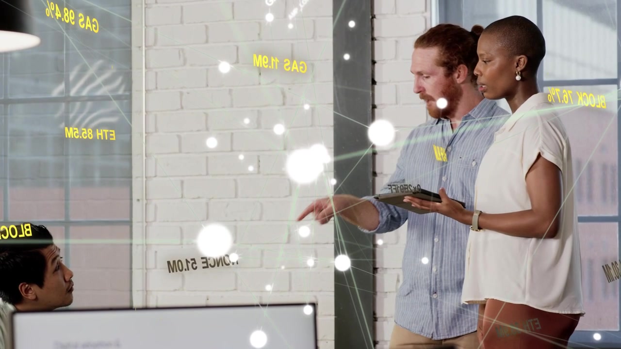 Business colleagues reviewing tablet data, woman tapping tablet causing animated overlay flaring