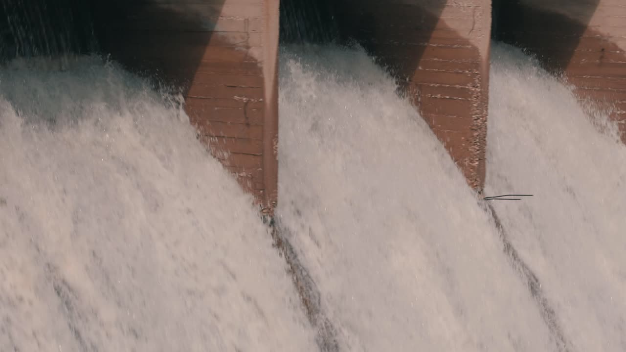 Water pouring from a dam used for irrigation close up