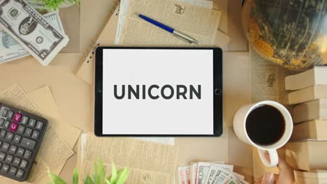 unicorn displaying on finance tablet screen