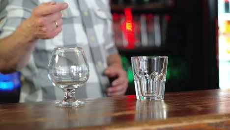 barman or bartender preparing alcohol cocktail in restaurant