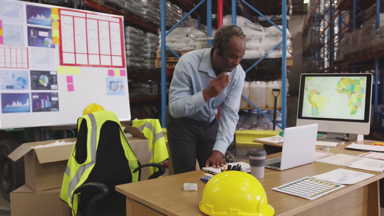 Man working at a desk in a warehouse 4k