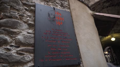 historical plaque in a narrow street