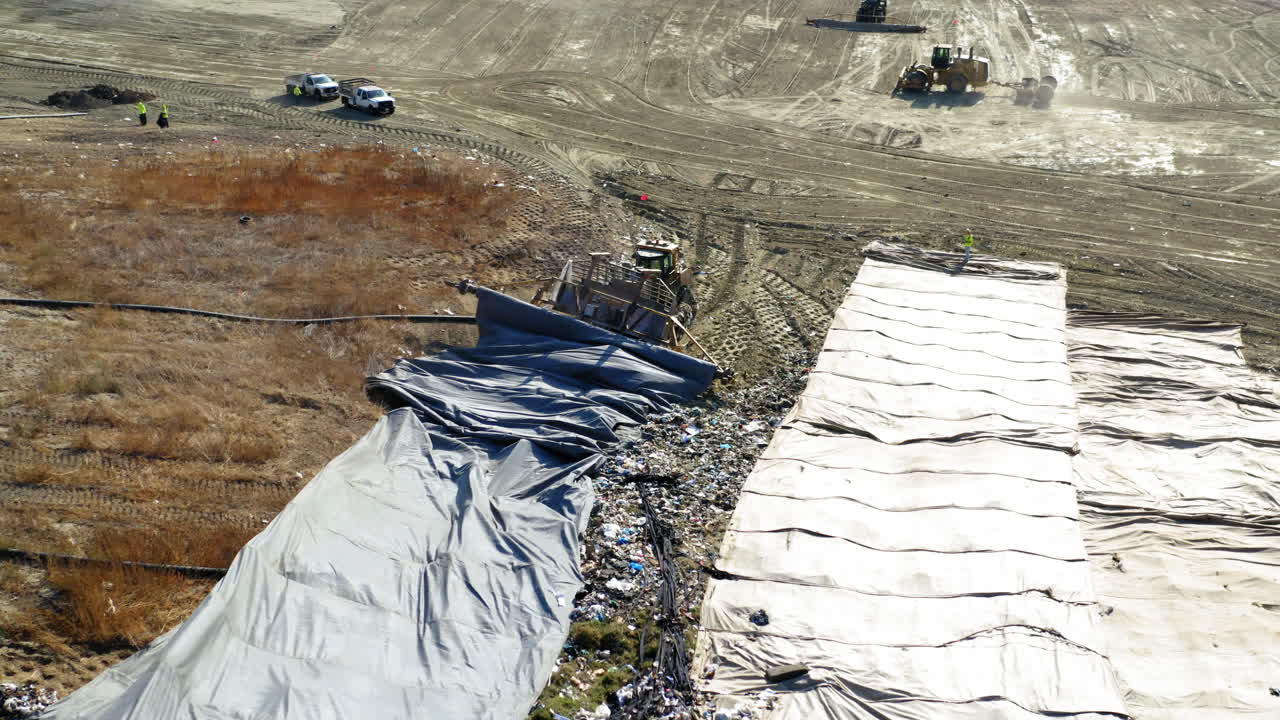 Aerial View of a Large Landfill with Heavy Machinery and Covered Waste