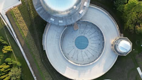 Stars-observatory-with-a-sundial-during-a-beautiful-summer-day,-surrounded-by-lush-greenery-under-a-clear-blue-sky