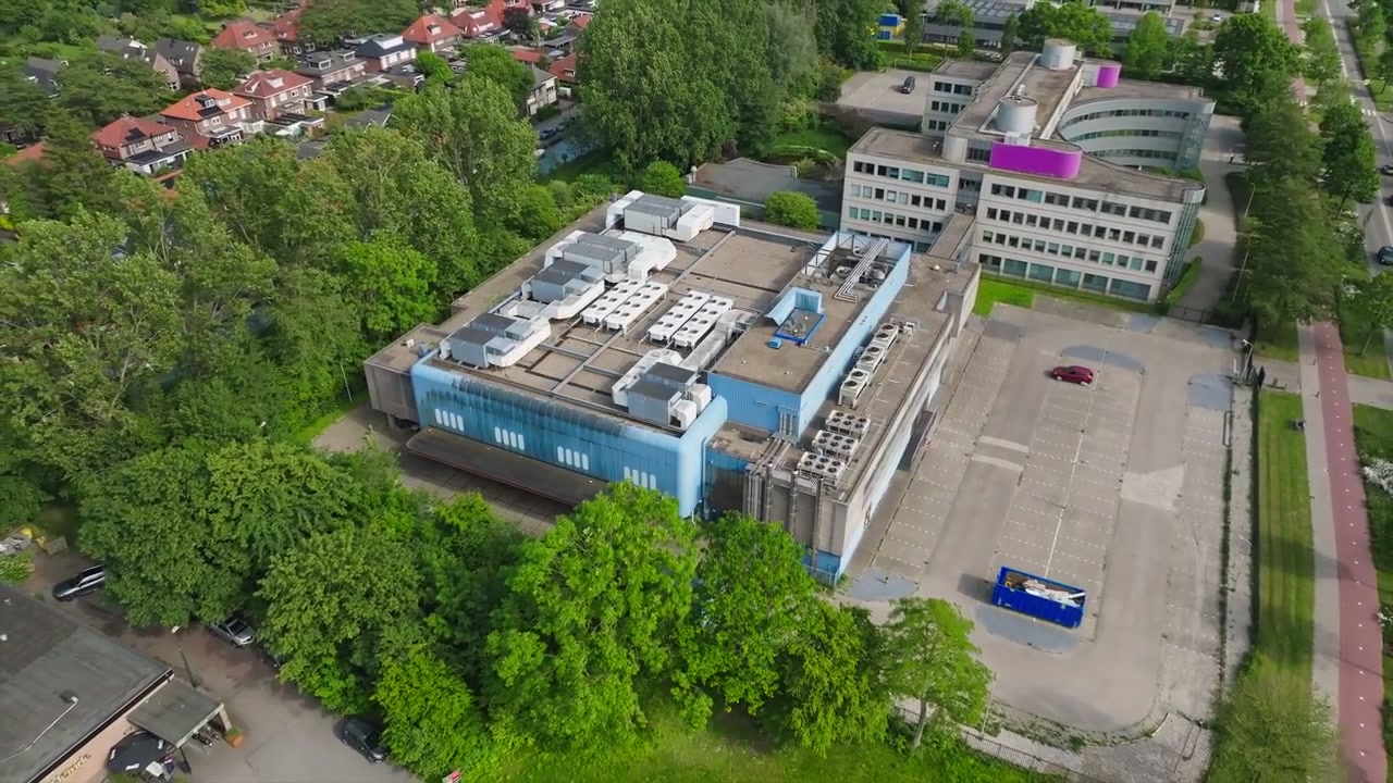 Aerial retreat modern data center building with roof ventilation in the Netherlands