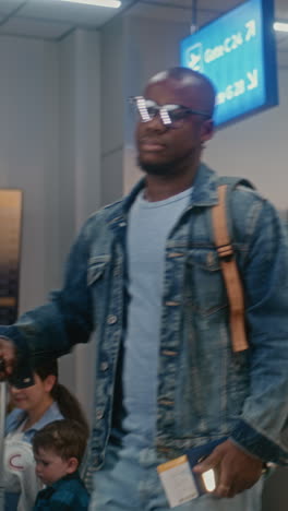 man at airport checking baggage and passport