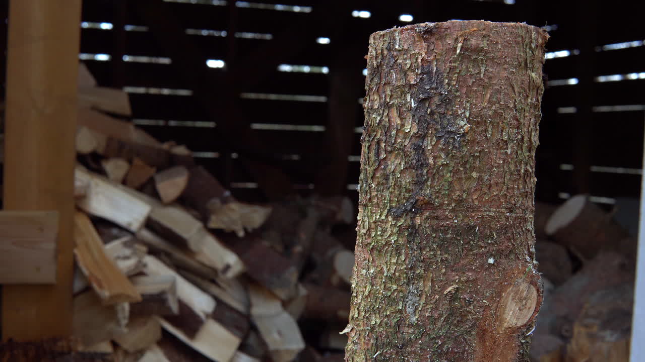 Chopping up firewood with a fast cut. Preparing for the winter. Springtime on the Swedish countryside,