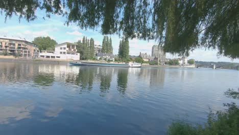 Barge-on-sunny-day-on-river-The-Maas-at-Huy,-Belgium,-Europe,-4K,-50fps