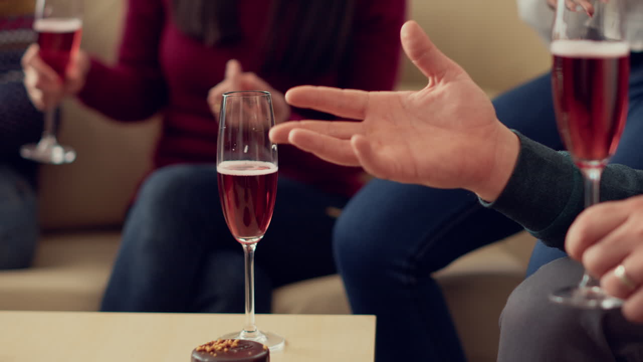 People serving glasses of wine at christmas party in office