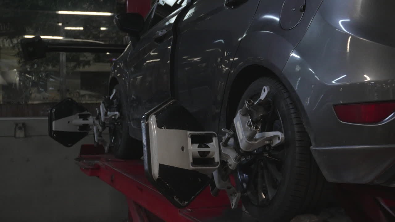Car wheel with alignment sensor equipment in a mechanical workshop
