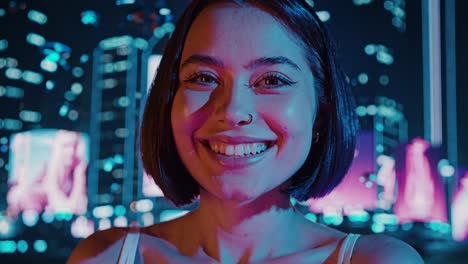 smiling woman in neon city lights