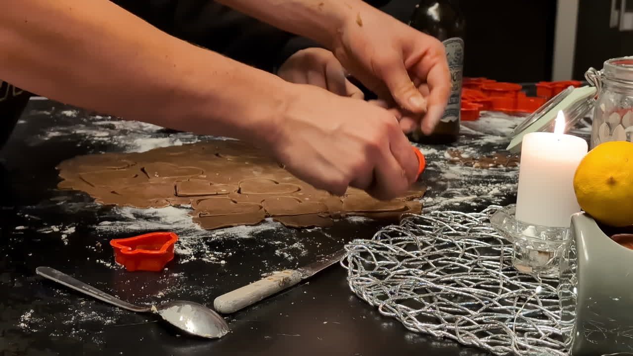 Close-up shot of hands Cutting gingerbread shapes with a cookie cutter