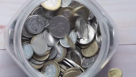 coins filling a glass jar