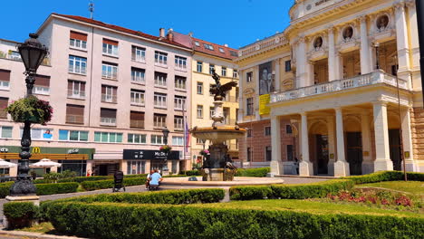 bratislava, slovakia, 2 june 2025: historical building of the slovak national theatre in bratislava, slovakia. amazing neo-renaissance architecture in the old town with a green lawn in front