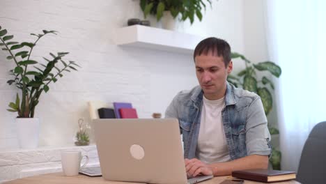 Head-shot-millennial-guy-sit-in-living-room-makes-video-call-looks-at-camera,-conversation-by-distant-videocall,-distance-hiring-job-interview-process,-tutor-and-trainee-study-on-line