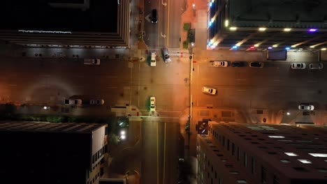 Intersection-in-Davenport,-Iowa-at-night-with-drone-video-overhead-looking-down-and-moving-down