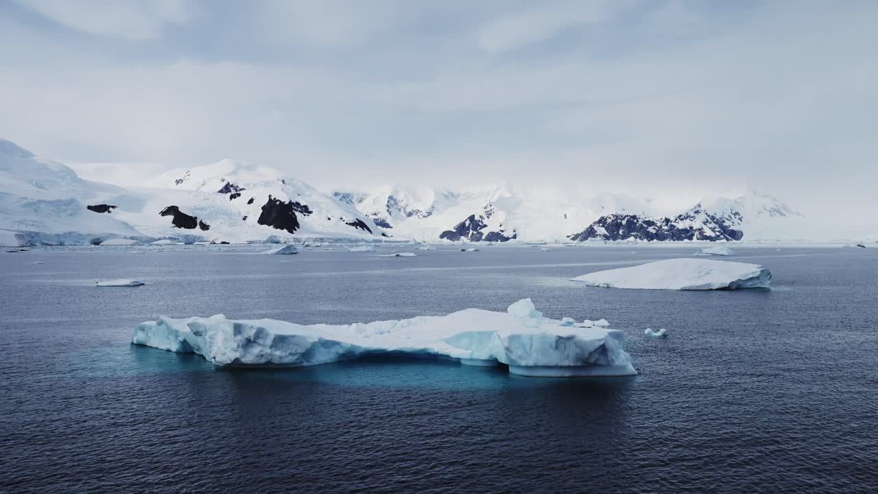 Mountains Iceberg and Winter Sea in Cold Blue Landscape Scenery, Antarctica Seascape with Ice and Glacier in Dramatic Beautiful Coastal Scene on Coast on Antarctic Peninsula, Moody Blue Atmosphric