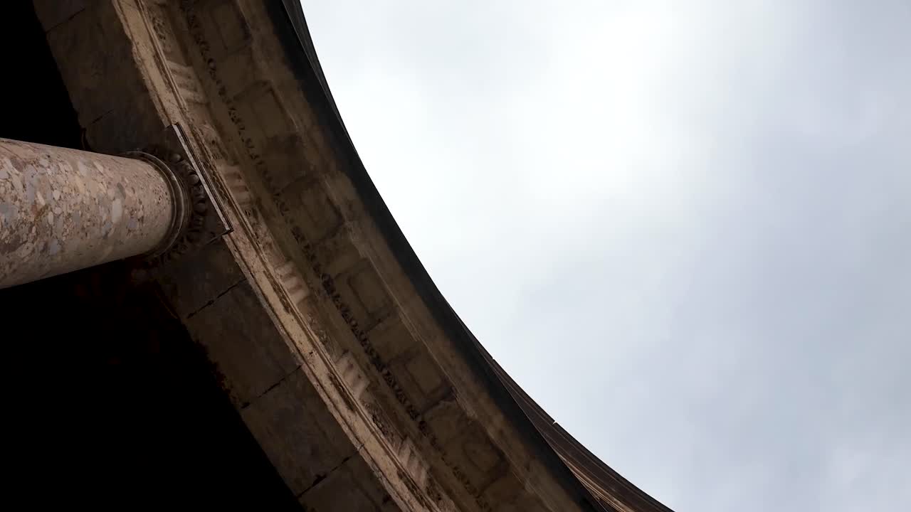 Nadir shot starting with the exterior details and ending inside the Palace of Charles V, part of the monumental complex of the Alhambra in Granada, Spain