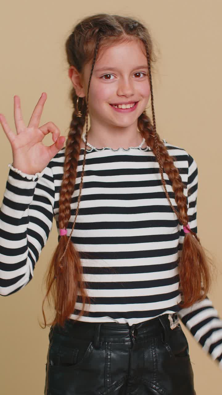 Happy child girl kid showing ok gesture like sign positive feedback celebrate victory approve idea
