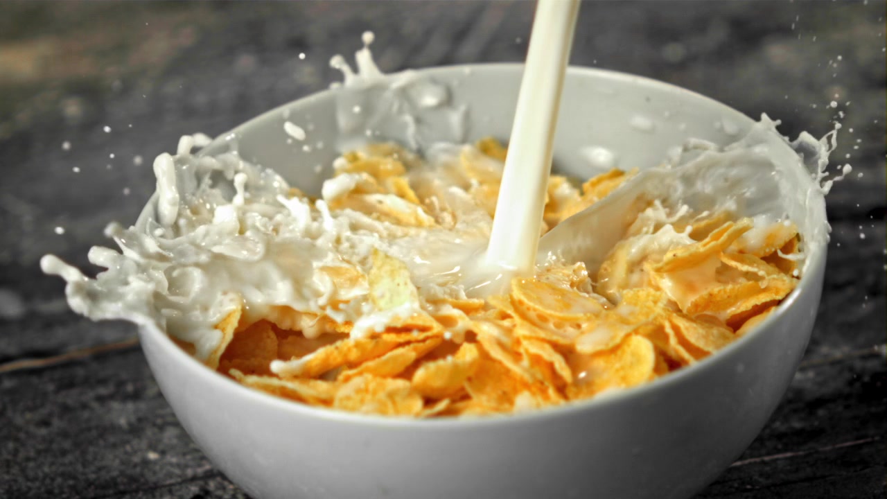 Slow Motion Milk Pouring into a Bowl of Cornflakes