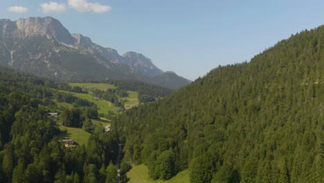 aerial truck right reveals european alpine mountains in background of rural countryside