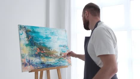 a contemporary artist who creates abstract works of art in the art nouveau style - close up of oil painting. a contemporary artist who creates abstract works of art in the art nouveau style. super slow motion