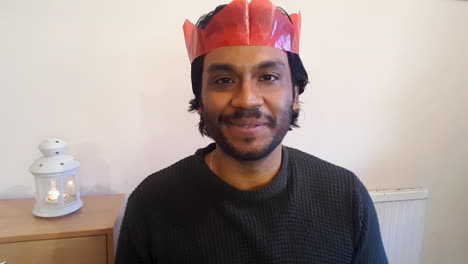 young man on christmas video call talking directly into the camera