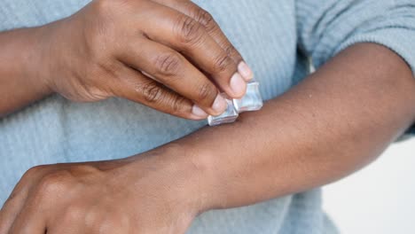 person rubbing ice cube on their wrist