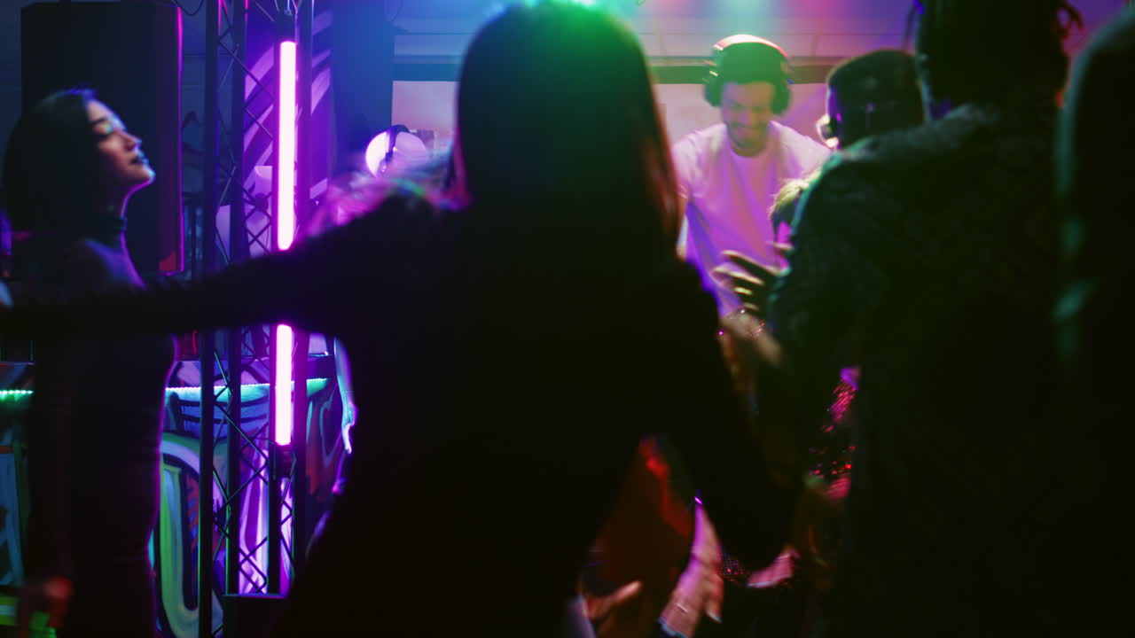 People Enjoying a Night Out at a Club with a DJ