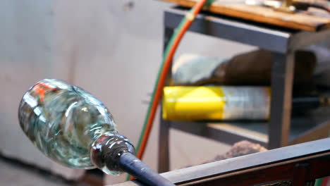 glassblower shaping a molten glass