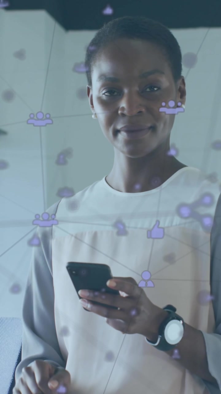 Animation of connected icons over african american woman using cellphone in office