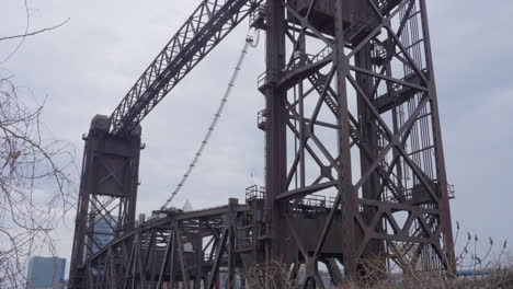 tilt up shot of historic vertical lift bridge in cleveland flats on cuyahoga river on a cloudy day