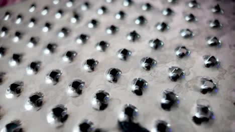 close-up view of shiny cheese grater with sharp metal holes