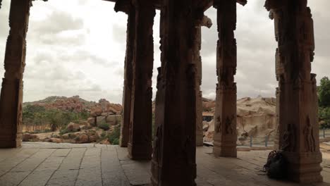 pan view, seeing through the rock pillers of the ruined temple at hampi