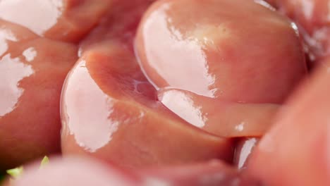 Raw-fresh-lamb-kidneys-on-a-chopping-board-,