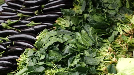 fresh spinach and eggplants at a farmers market