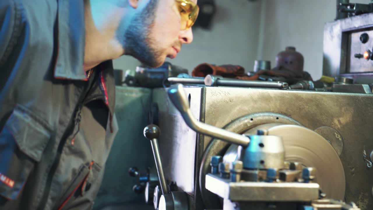 Industrial worker works at a metallurgical plant. Modern equipment for metal cutting.
