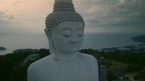 giant buddha statue at sunset in phuket, thailand