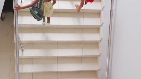 Video-of-top-view-of-diverse-girls-walking-upstairs-at-school